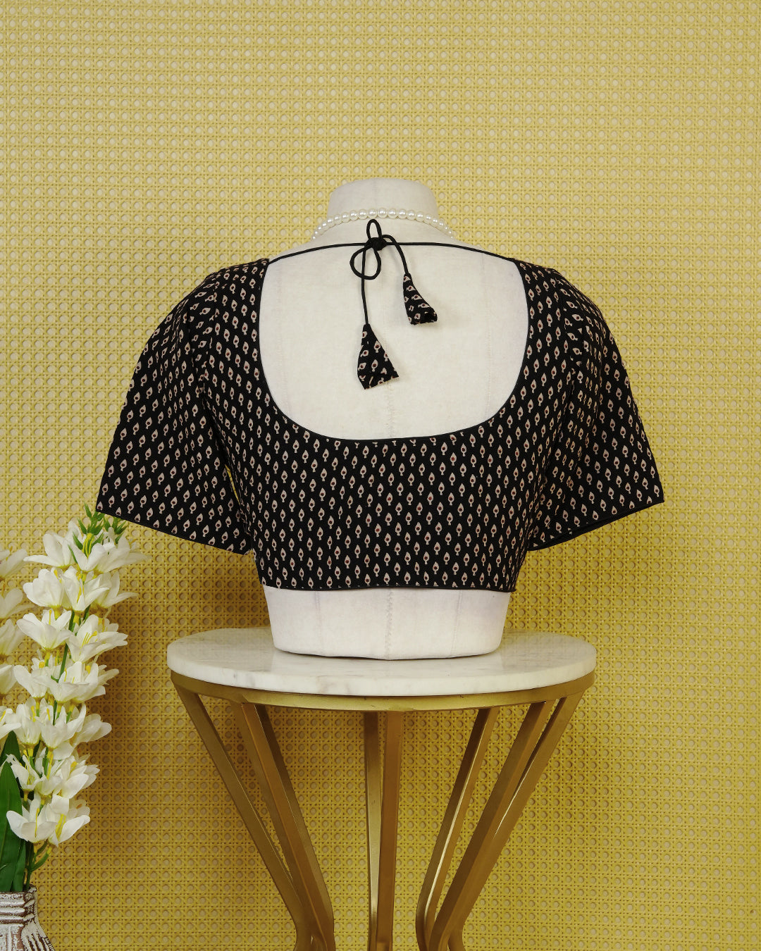Black Colour Printed Blouse Featuring An All Over Small Teardrop Motif Pattern, Enhanced With A Round Neckline, Front Button Closure, And Short Sleeves.