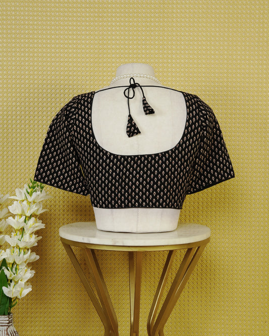 Black Colour Printed Blouse Featuring An All Over Small Teardrop Motif Pattern, Enhanced With A Round Neckline, Front Button Closure, And Short Sleeves.