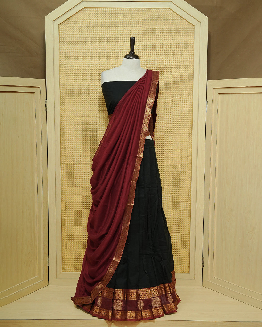 Black Colour chettinad cotton Semi stitched dhavani set featuring Contrast Maroon with Gold zari border skirt, comes with Matching blouse piece & dupatta.