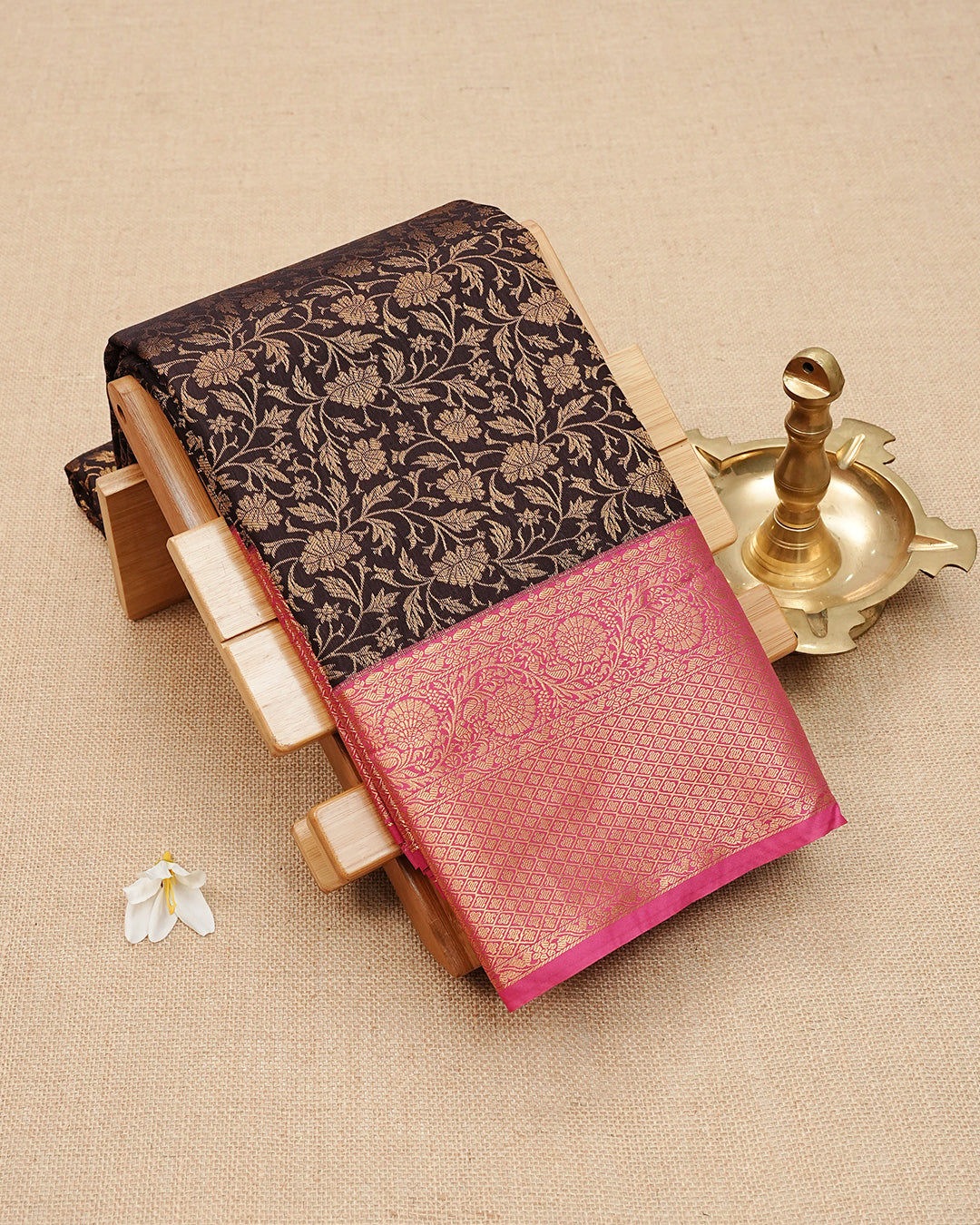 Dark Brown colour semi wedding saree featuring  gold zari Floral kodi  Pattern on body, contrast Rani Pink colour with traditional border, paired with matching blouse piece.