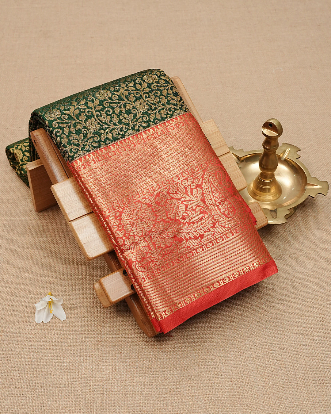 Dark green semi wedding saree with elegant gold zari floral motifs On Body, complemented by a contrast Red zari border and rich traditional pallu. Comes with a matching blouse piece.