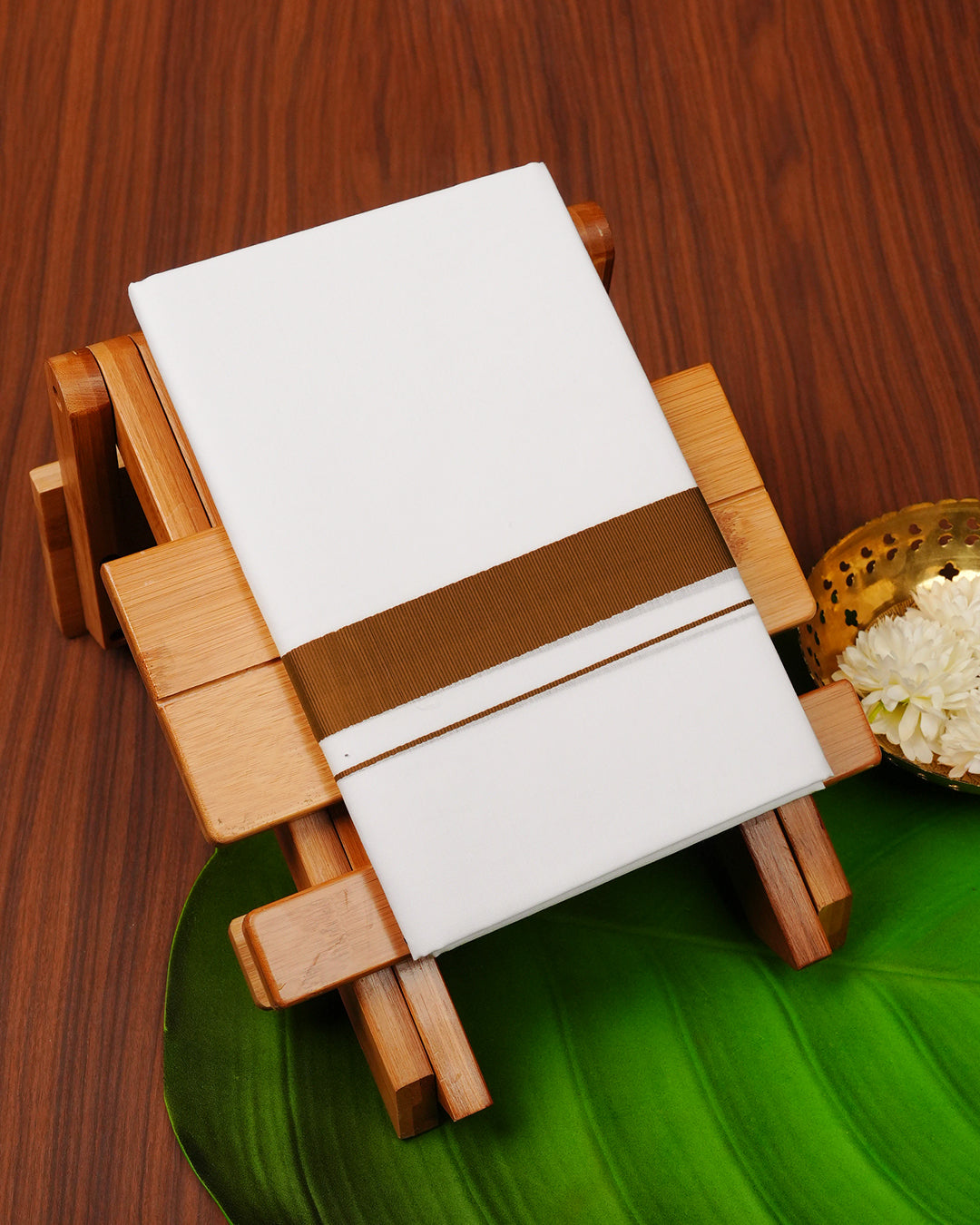 White colour cotton single dhoti featuring Brown border.