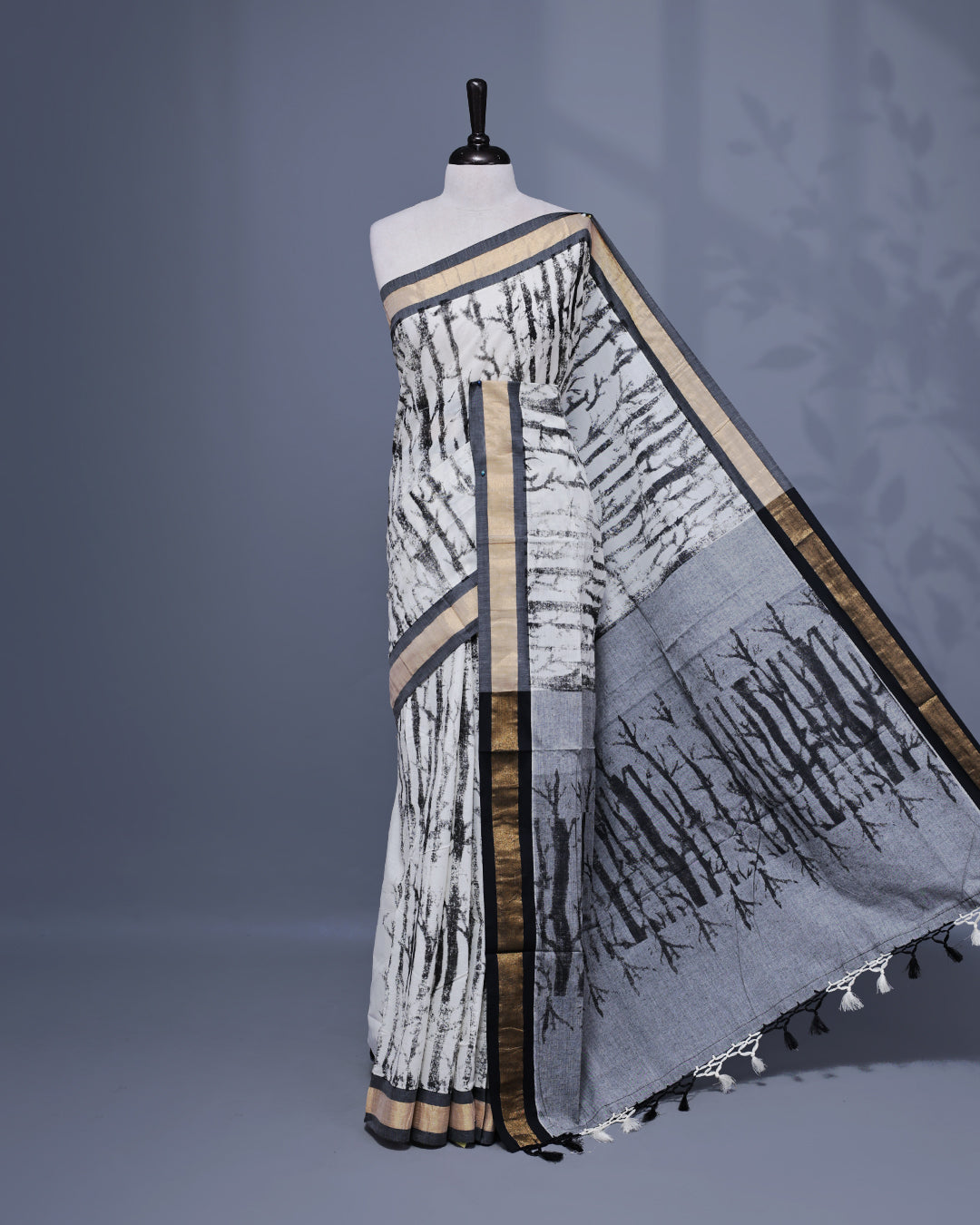 Cream colour Semi chanderi kerala saree featuring Black colour Print on body, complemented by Light Gold zari & black Border, paired with matching blouse piece.