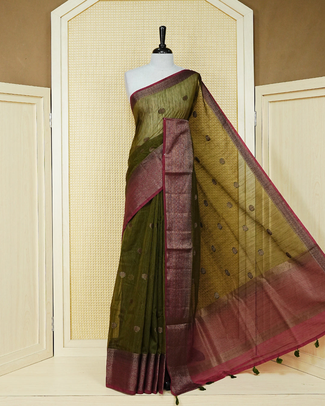 Dark olive colour semi linen saree thread motifs on body, contrast wine colour gold zari border, rich pallu comes with matching blouse piece