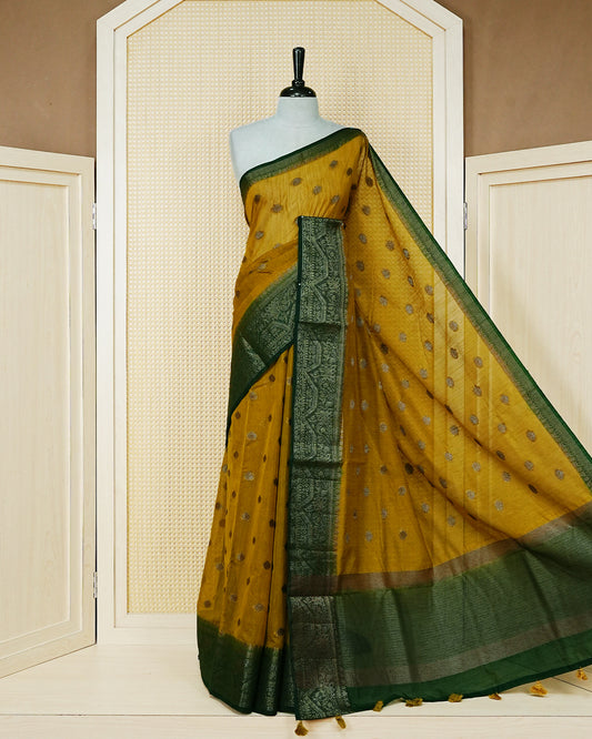 Mustard yellow colour semi linen saree thread motifs on body, contrast Dark green colour gold zari border, rich pallu comes with matching blouse piece