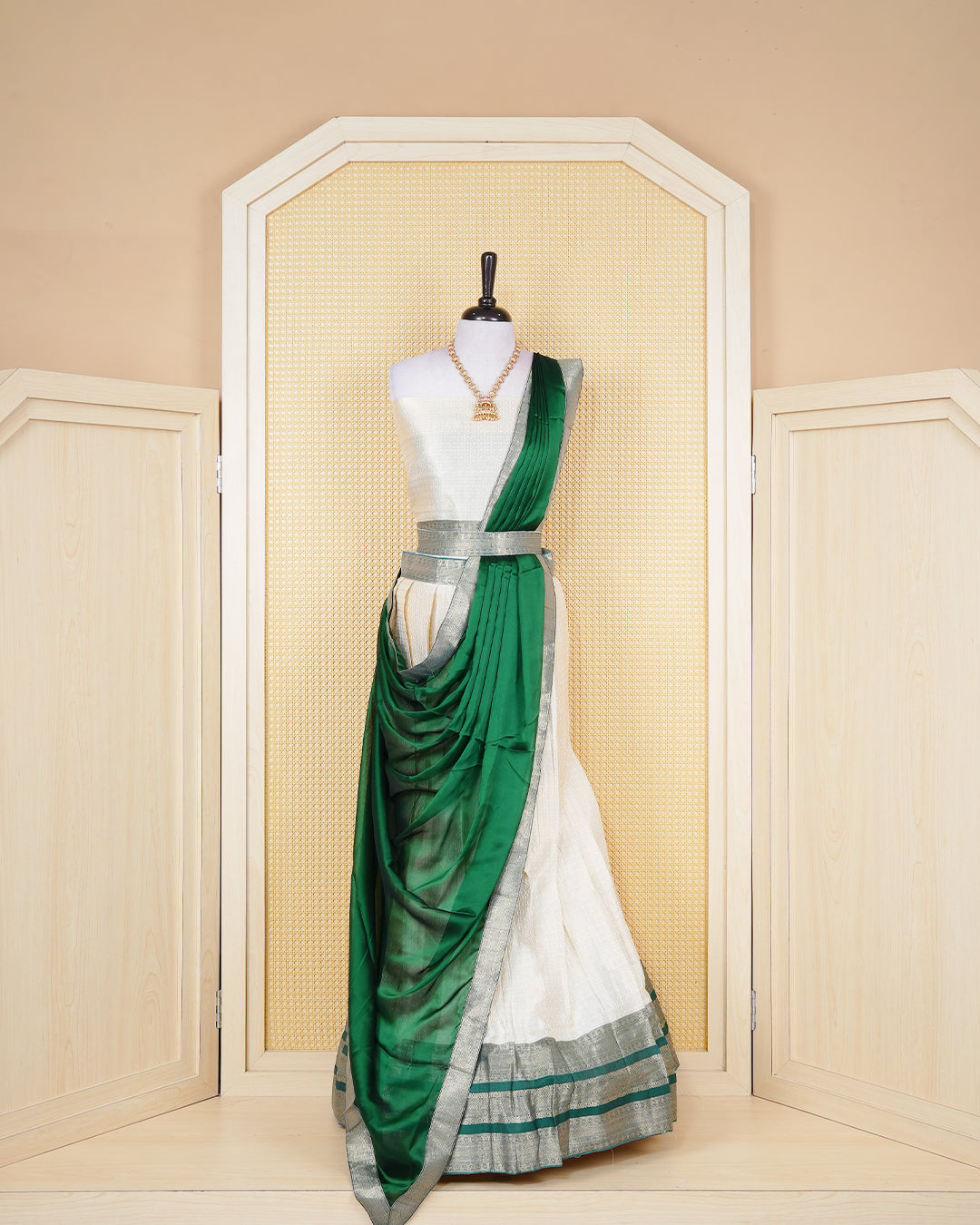 Cream colour  tissue Semi stitched dhavani set featuring Gold zari check pattern with motifs on body ,contrast Green colour with gold zari bordered skirt, paired with matching blouse piece & dupatta.