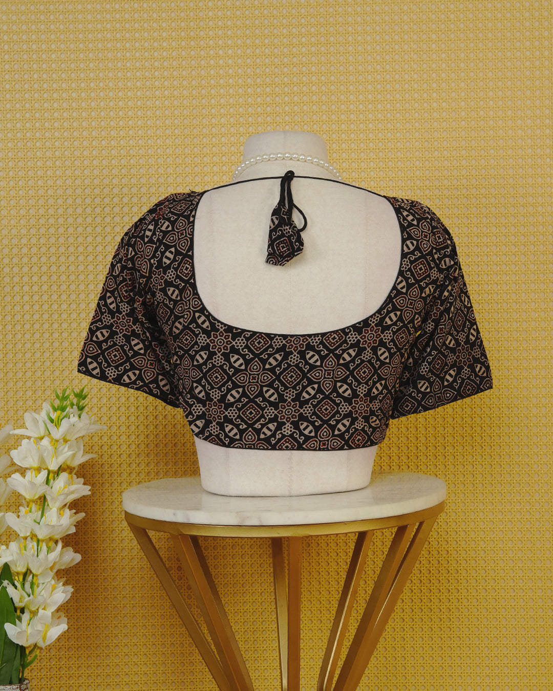 Black Colour Blouse Featuring A Classic U-Neck, Intricate Geometric Printed Design, And Comfortable Elbow Length Sleeves.