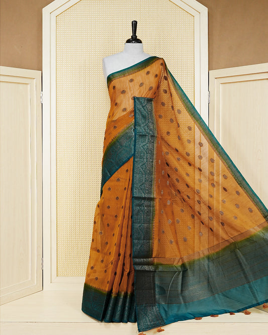 Mustard yellow colour semi linen saree thread motifs on body, contrast dark teal colour gold zari border, rich pallu comes with matching blouse piece
