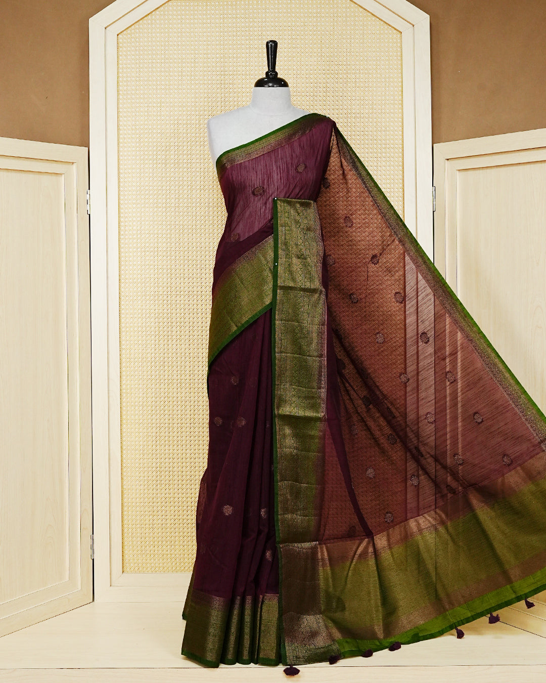 Wine colour semi linen saree thread motifs on body, contrast mehndi green colour gold zari border, rich pallu comes with matching blouse piece