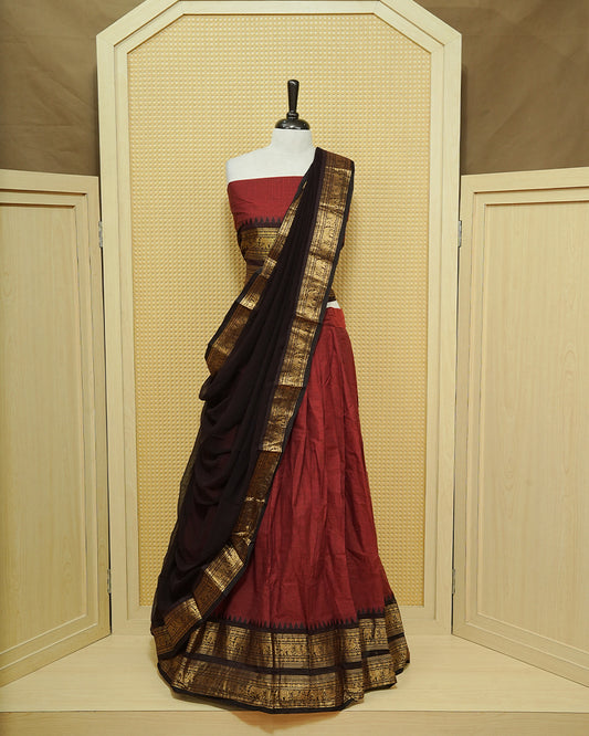 Maroon colour Chettinad Semi Stitched dhavani set Featuring contrast Black with Gold zari border on skirt, Contrast Blouse & matching dupatta.