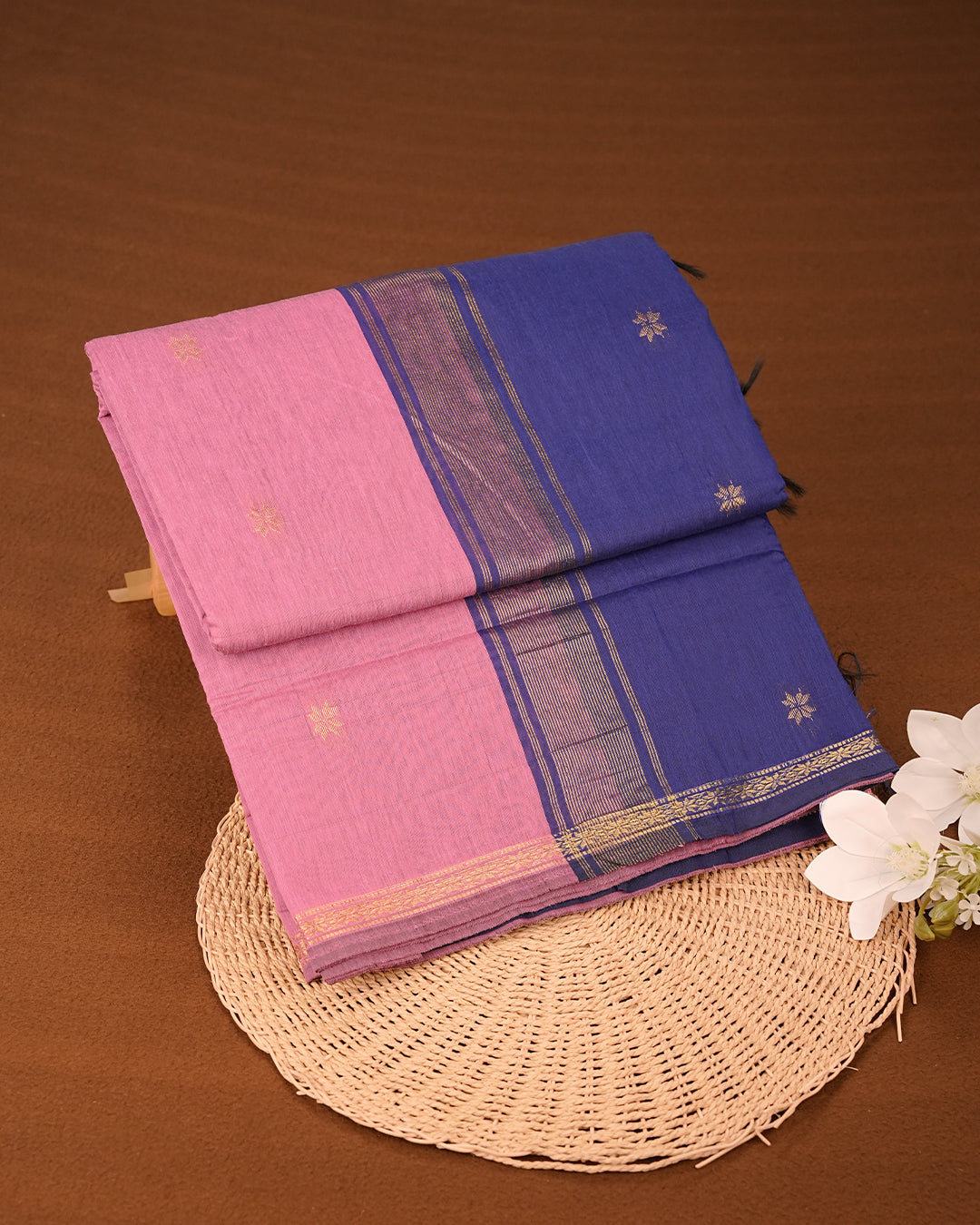 Pink colour kalyani cotton saree featuring gold zari Floral pattern on body, complemented by Blue colour with Stripes & Floral Gold zari border, paired with matching blouse piece