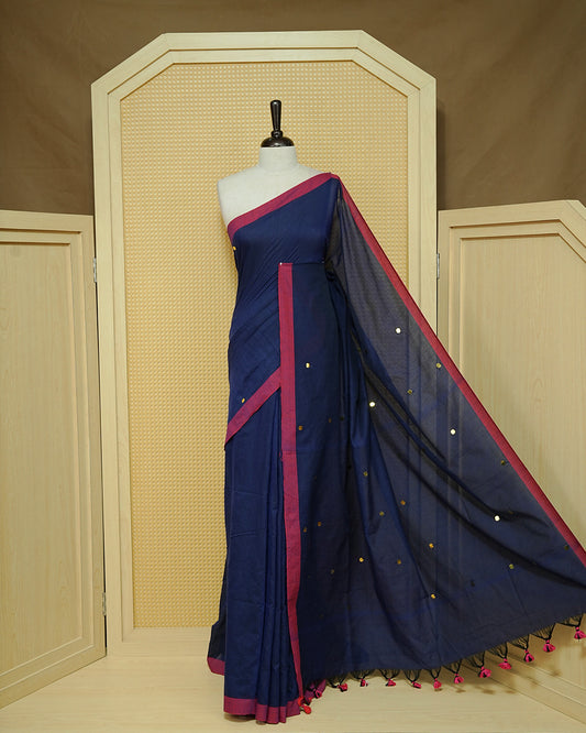 Navy Blue colour Mul cotton saree featuring Gold Sequins, complemented by Contrast Magenta simple Border & tassels.