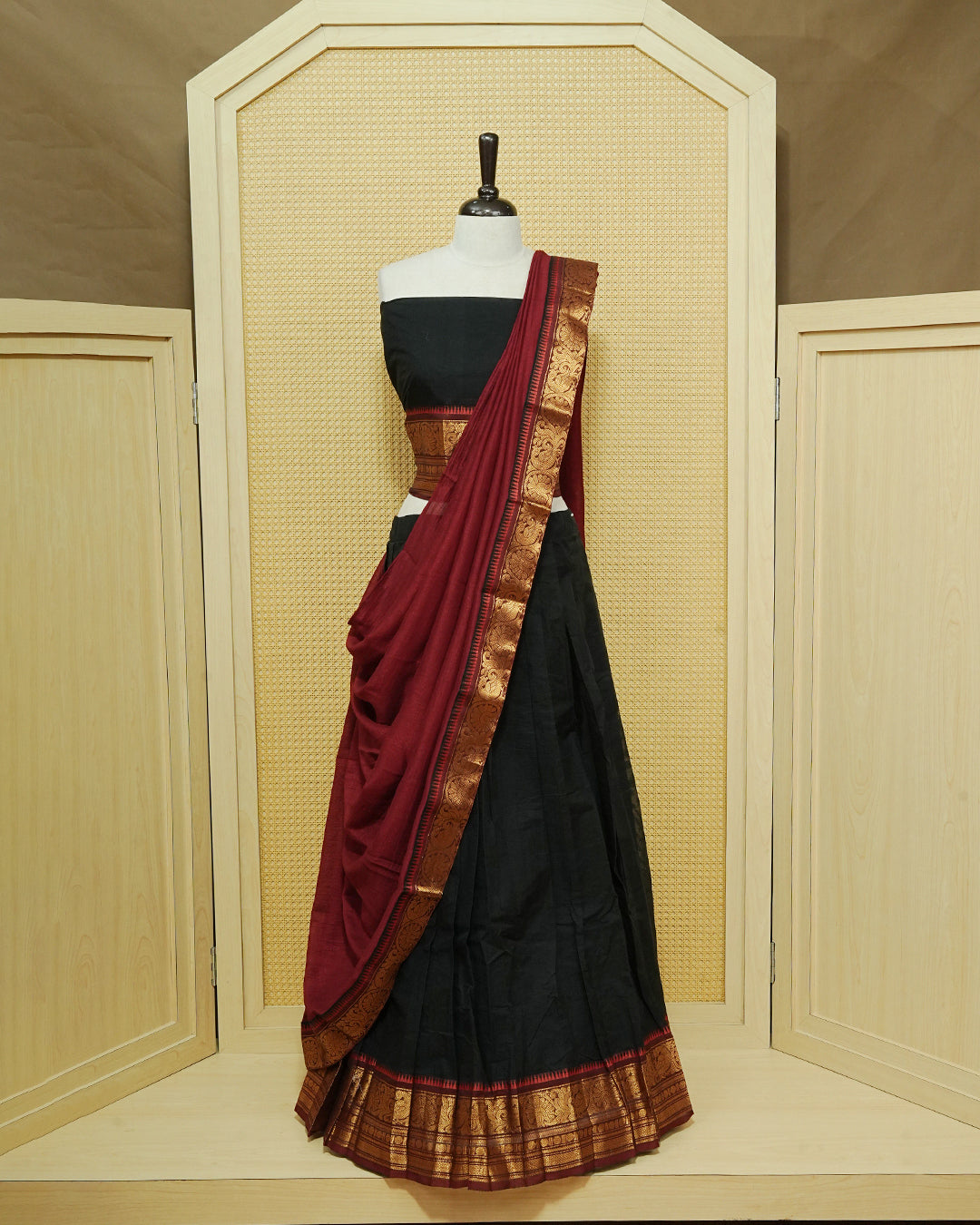 Black Colour chettinad cotton Semi stitched dhavani set featuring Contrast Maroon with Gold zari border skirt, comes with Matching blouse piece & dupatta.