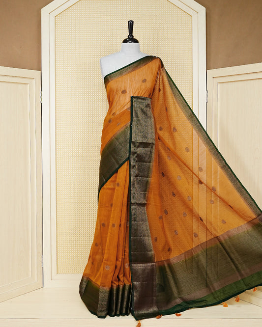 Mustard yellow colour semi linen saree thread motifs on body, contrast dark green colour gold zari border, rich pallu comes with matching blouse piece