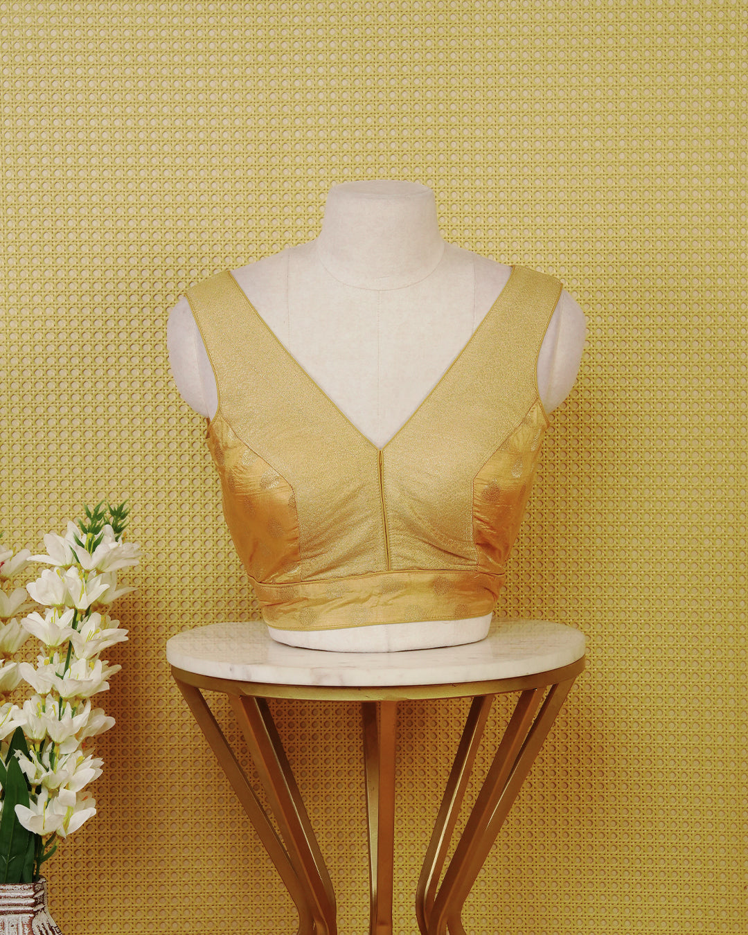 Gold colour Sleeveless Blouse Featuring A Stylish V-Neck, Elegant Woven Pattern With Gold Butta Motifs, And A Comfortable Tailored Fit.