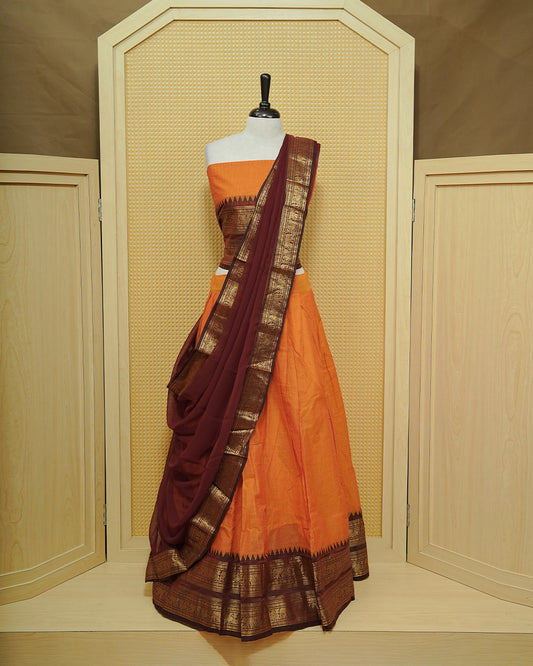 Orange colour Chettinad Semi Stitched dhavani set Featuring contrast Maroon with Gold zari border on skirt, Contrast Blouse & matching dupatta.