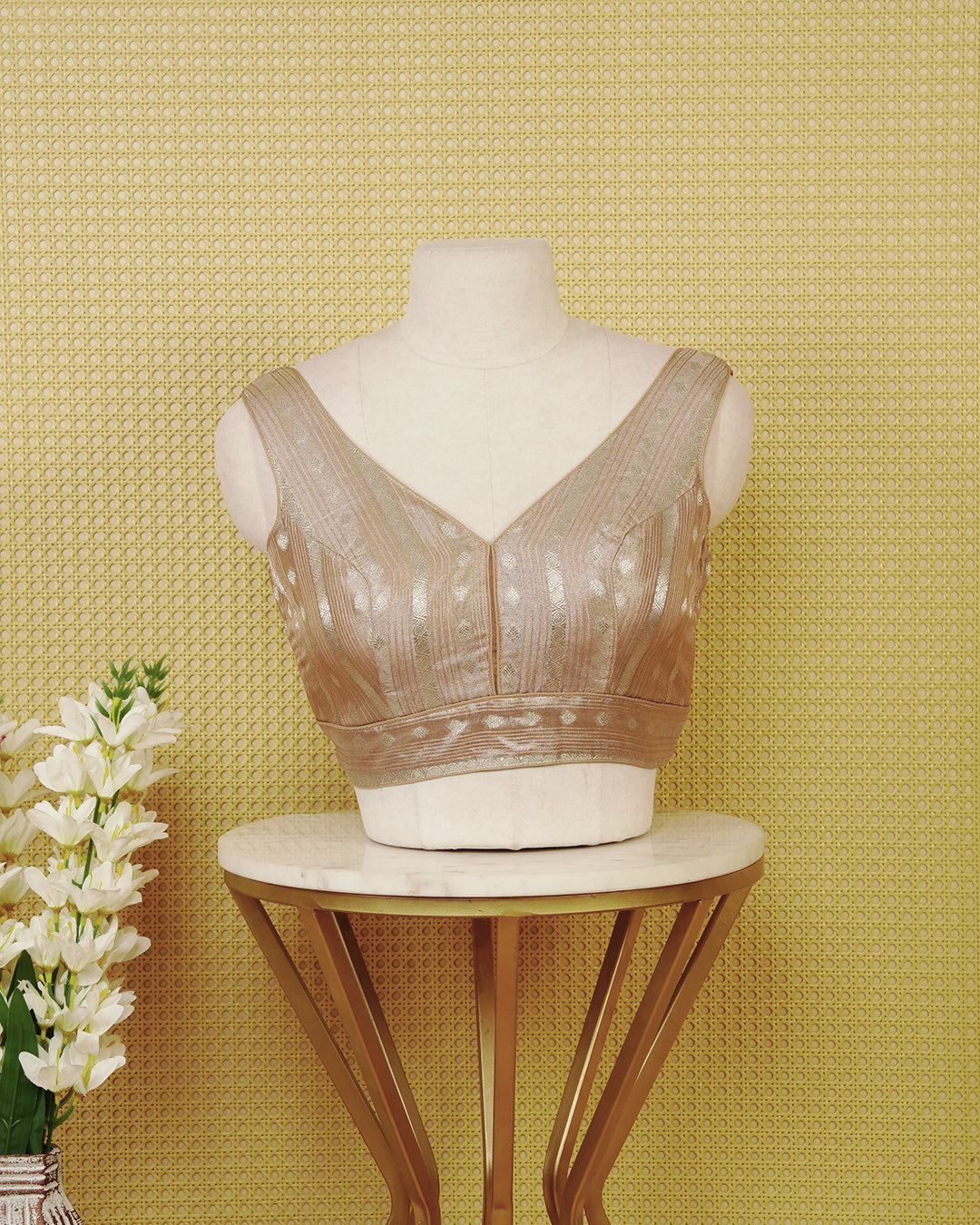 Light brown colour Sleeveless Blouse Featuring A Stylish V-Neck, Elegant Woven Zari Stripes With Butta Motifs, And A Comfortable Tailored Fit.