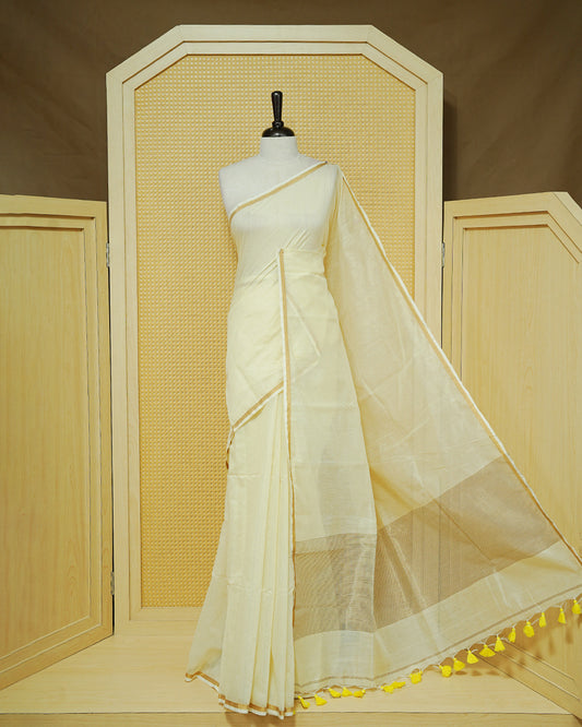 Cream Mul Cotton Saree featuring a graceful plain body with a subtle gold zari border and a finely woven striped pallu. Finished with vibrant Yellow tassels