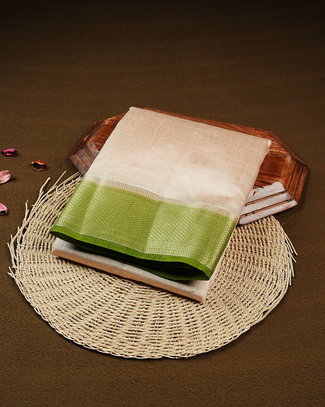 Light gold colour Semi Tussar silk saree featuring an elegant plain body, accentuated by a contrast Light green border adorned with intricate gold zari work, paired with a matching blouse piece.