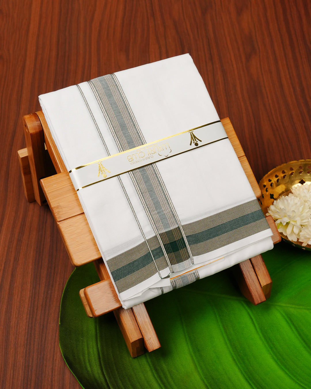 White colour RAMRAJ cotton single dhoti featuring Light Gold with green colour  border.