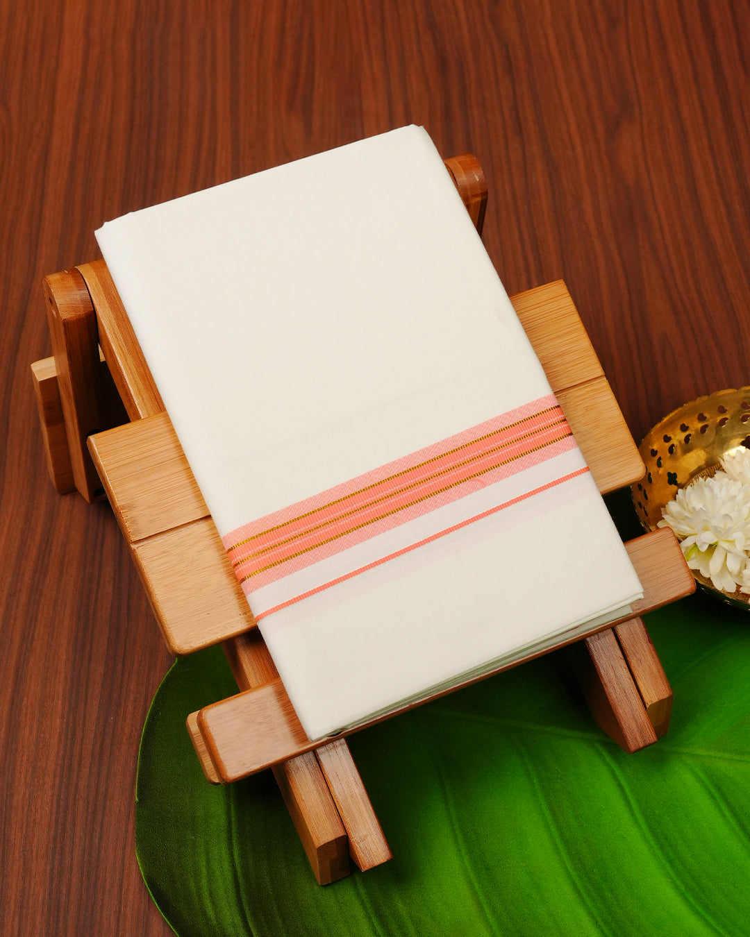 Cream colour cotton single dhoti featuring Peach colour with gold zari border.