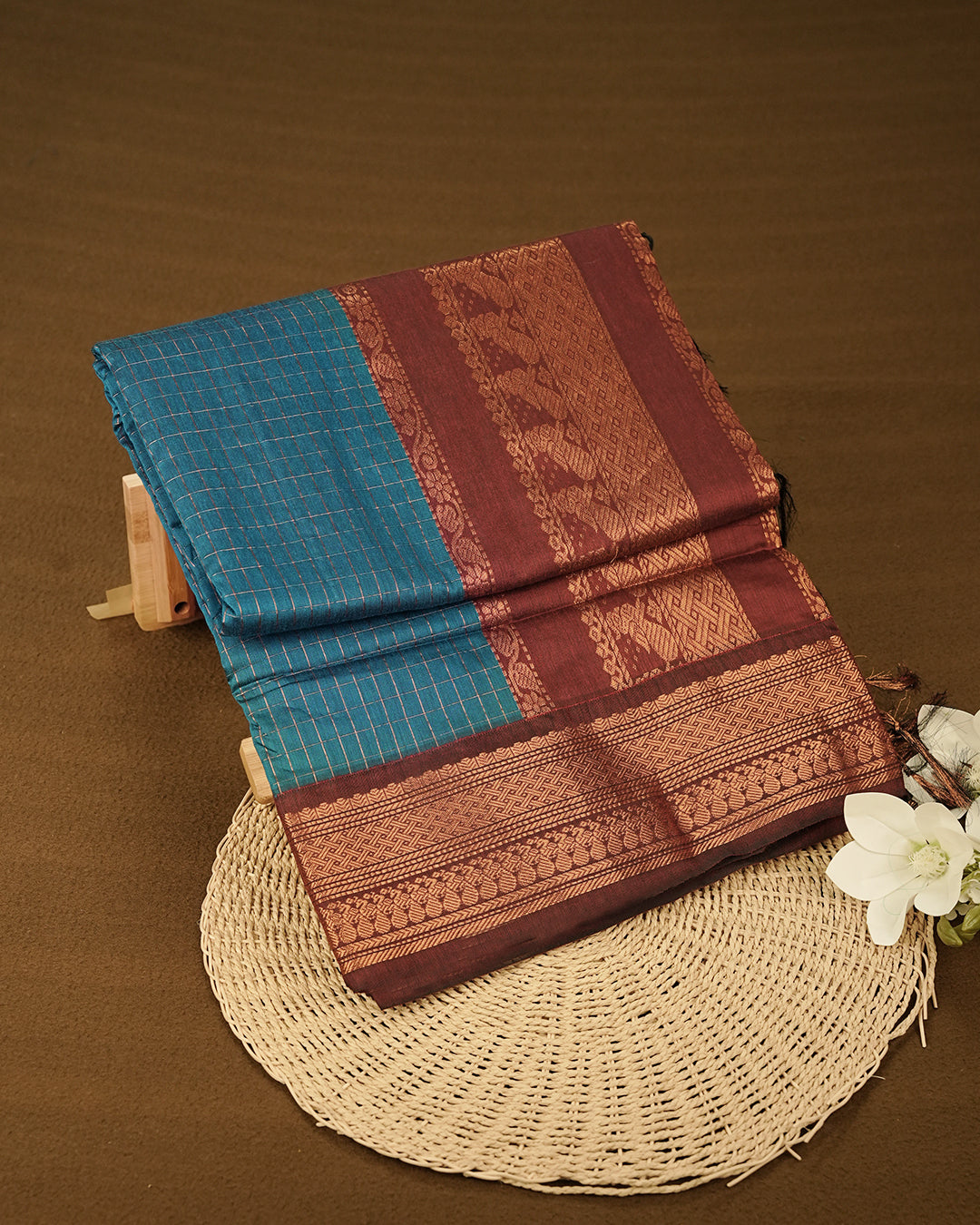 Peacock Blue colour kalyani cotton saree featuring Copper zari check pattern on body, complemented by Maroon colour with Antique zari border, paired with matching blouse piece