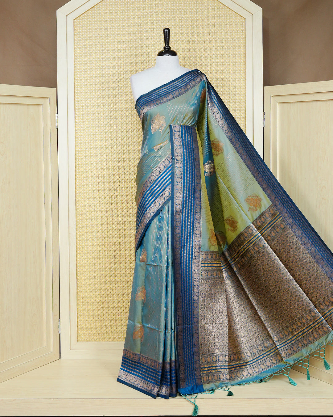 Green & gold double shade Mulberry silk saree featuring floral gold zari patterns on body , paired with contrast teal colour with traditional border, comes with matching blouse piece.