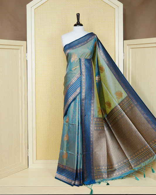 Green & gold double shade Mulberry silk saree featuring floral gold zari patterns on body , paired with contrast teal colour with traditional border, comes with matching blouse piece.