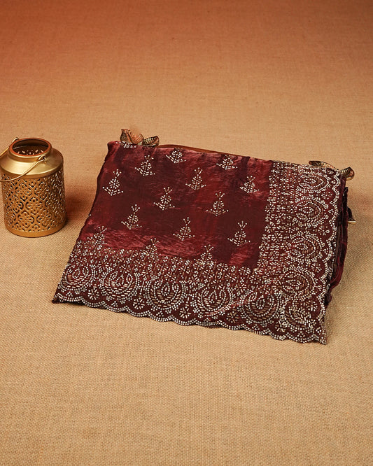 Maroon colour Velvet chiffon designer saree featuring Stone & Cut beats work on body,and border, comes with matching blouse piece.