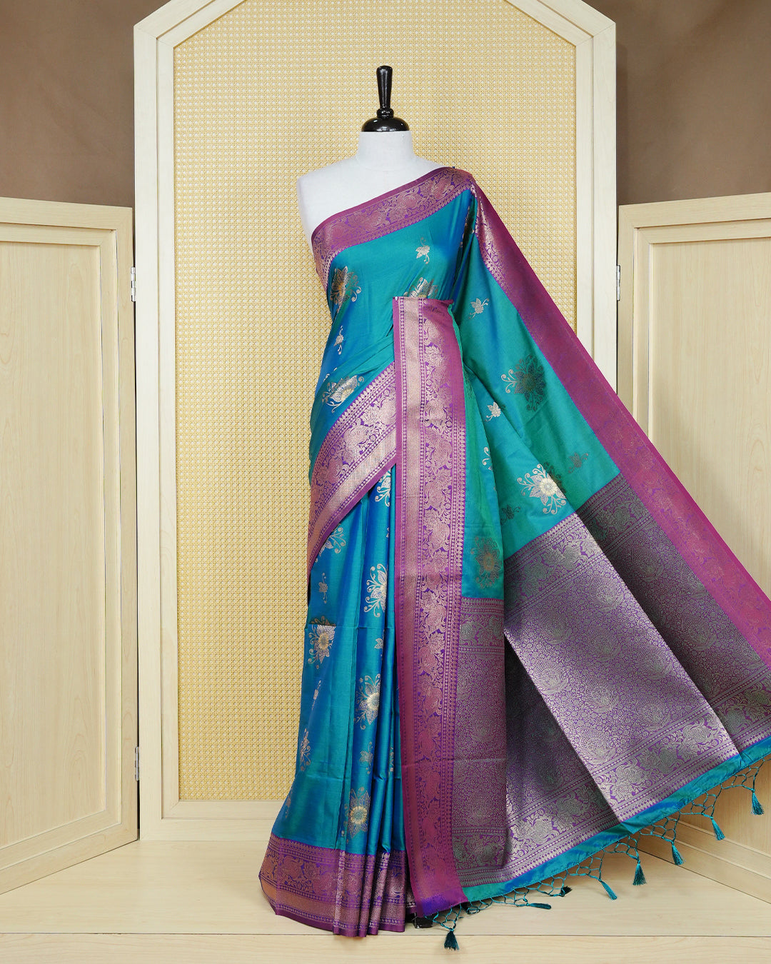 Peacock green Mulberry silk saree featuring gold floral zari patterns on body, paired with contrast wine colour with traditional border, comes with matching blouse piece.