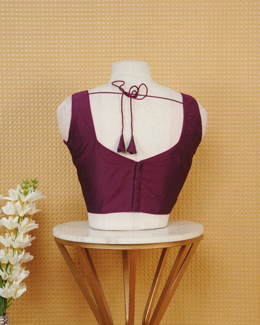 Burgundy colour Sleeveless Blouse Featuring A Stylish Sweetheart Neck, Smooth Finish, And A Comfortable Tailored Fit.