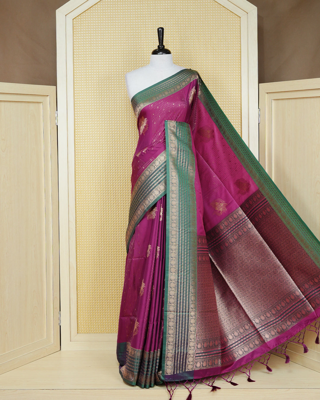 Purple colour Mulberry silk saree featuring gold floral zari patterns on body, paired with contrast green colour with traditional border, comes with matching blouse piece.
