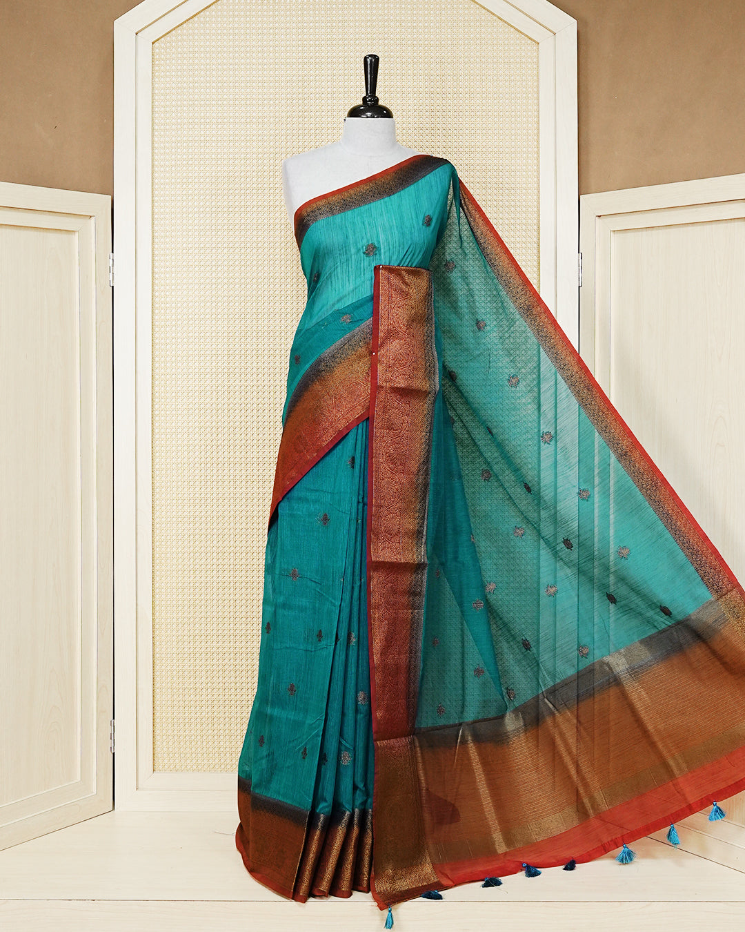 Teal blue colour semi linen saree thread motifs on body, contrast green colour gold zari border, rich pallu comes with matching blouse piece