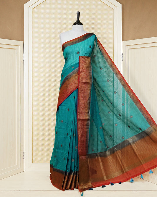 Teal blue colour semi linen saree thread motifs on body, contrast green colour gold zari border, rich pallu comes with matching blouse piece