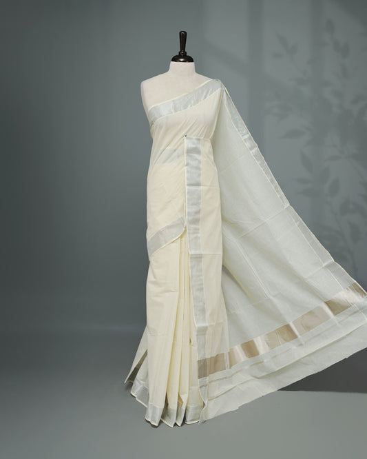 Cream colour Kerala saree Featuring an Elegant plain body, complemented by a classic Silver & Rose gold zari border, matching blouse piece.