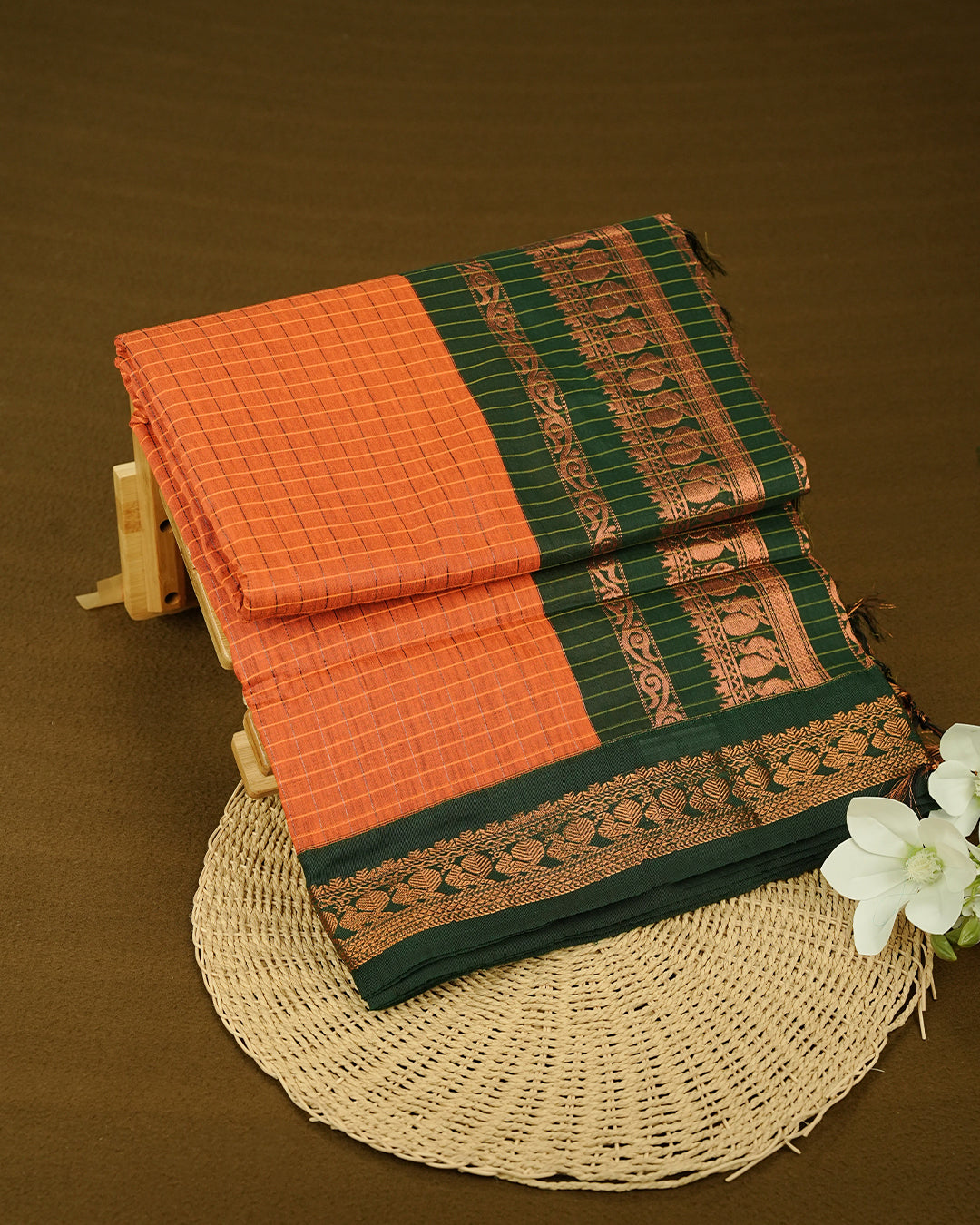 Orange colour kalyani cotton saree featuring Copper zari check pattern on body, complemented by Green colour with Antique zari border, paired with matching blouse piece