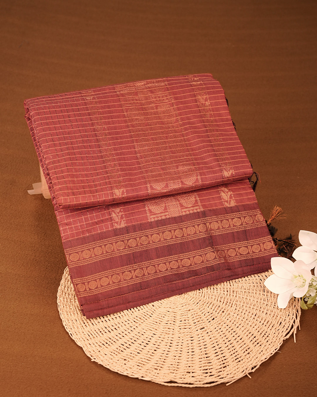 Maroon colour kalyani cotton saree featuring gold zari check pattern on body, complemented by Brown colour with Antique zari border, paired with matching blouse piece