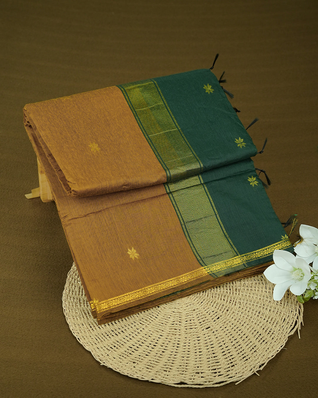 Dark Mustard  colour kalyani cotton saree featuring gold zari Floral pattern on body, complemented by Green colour with Stripes & Floral Gold zari border, paired with matching blouse piece