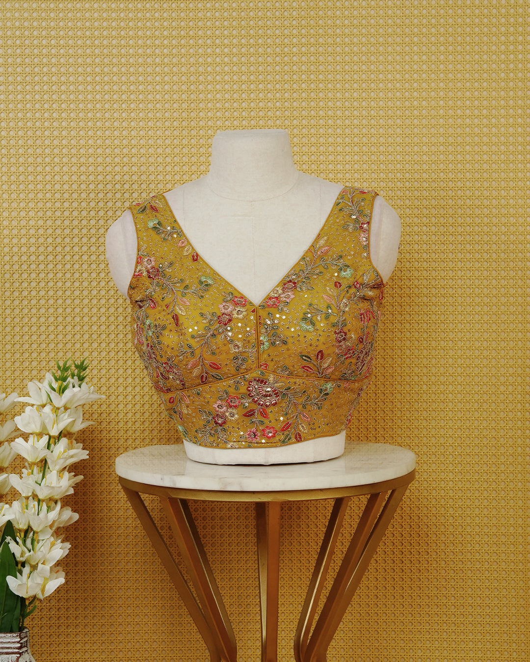 Mustard Yellow colour Sleeveless Blouse Featuring A Stylish V-Neck, Intricate Floral Embroidery With Sequin Detailing, And A Comfortable Tailored Fit.