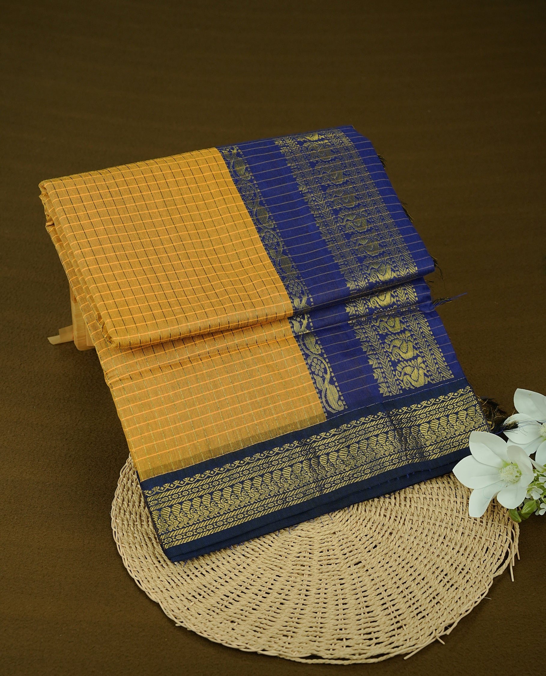 Mustard colour kalyani cotton saree featuring gold zari check pattern on body, complemented by Violet colour with Antique zari border, paired with matching blouse piece