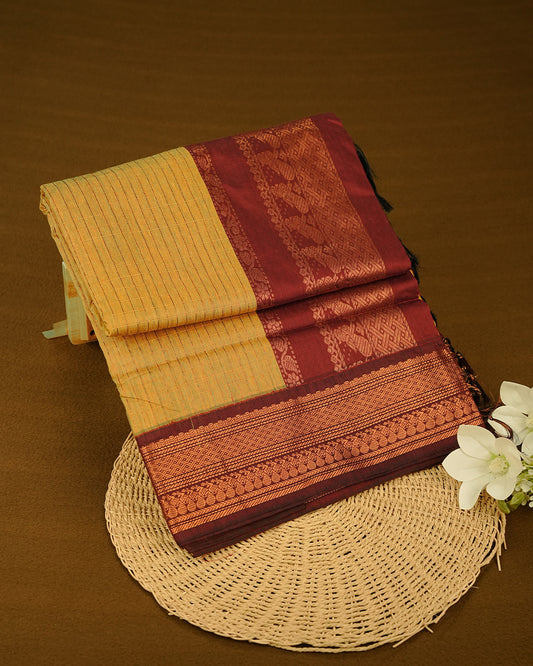 Mustard colour kalyani cotton saree featuring Copper zari check pattern on body, complemented by Brown colour with Antique zari border, paired with matching blouse piece