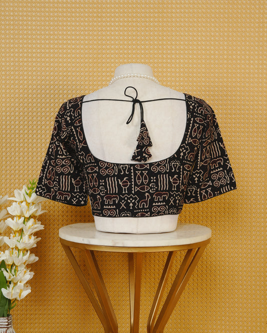 Black Colour Printed Blouse Featuring An All Over Tribal Inspired Geometric Motif Pattern, Enhanced With A Round Neckline, Front Button Closure, And Short Sleeves.