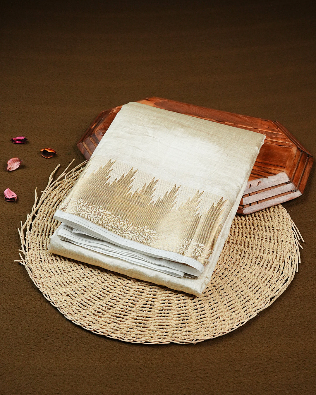 Off white gold Tussar saree featuring Gold zari buttas on body, complemented by self colour with traditional border, comes with matching blouse piece.