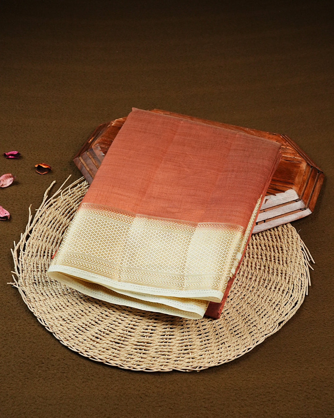 Orange colour Semi Tussar silk saree featuring an elegant plain body, accentuated by a contrast cream border adorned with intricate gold zari work, paired with a matching blouse piece.
