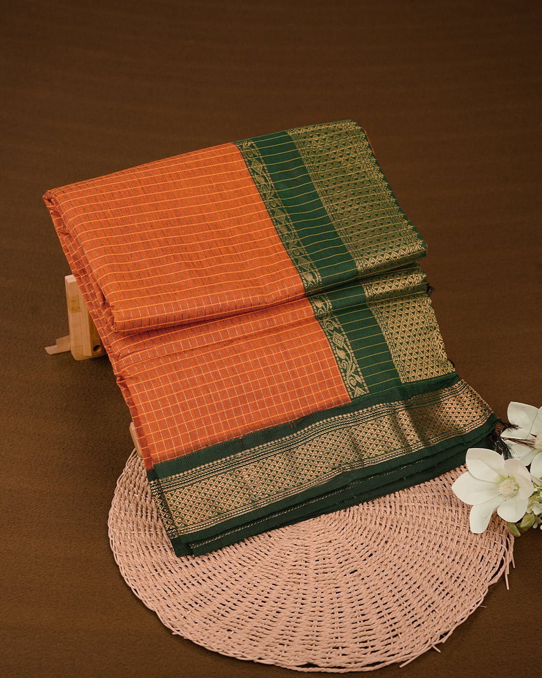 Orange colour kalyani cotton saree featuring gold zari check pattern on body, complemented by Green colour with Antique zari border, paired with matching blouse piece