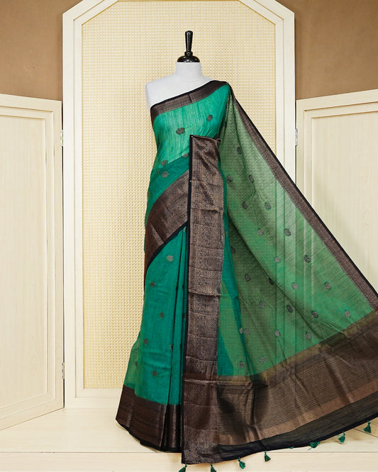 Bottle green colour semi linen saree thread motifs on body, contrast black colour gold zari border, rich pallu comes with matching blouse piece