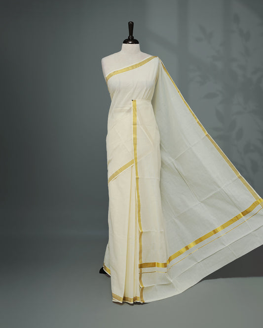 Cream colour Kerala saree Featuring an Elegant plain body, complemented by a classic simple gold zari border, matching blouse piece.