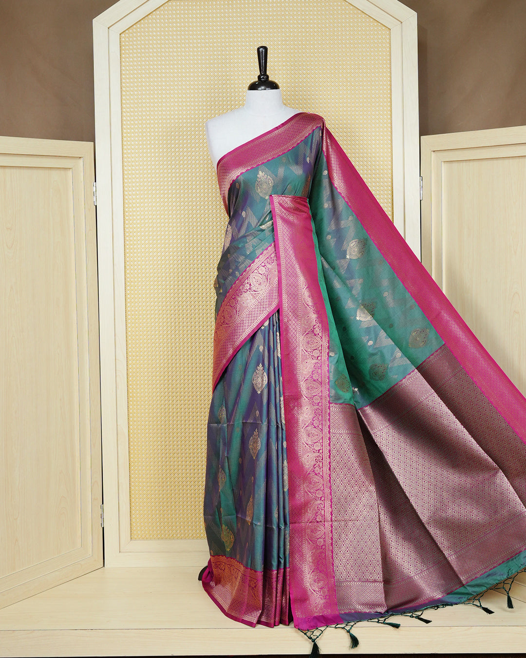 Green colour Mulberry silk saree featuring gold floral zari patterns on body, paired with contrast magenta colour with traditional border, comes with matching blouse piece.