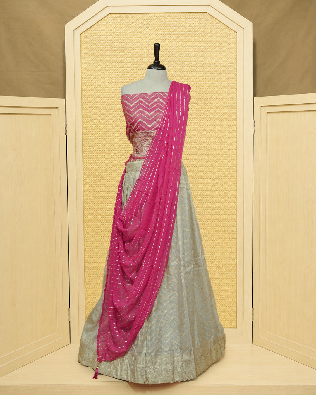 Cream colour Semi Stitched Dhavani set Featuring Gold zari Zigzag pattern With Traditional border skirt, Contrast Pink colour Dupatta, Matching blouse piece.
