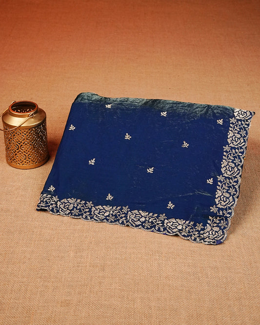 Peacock blue colour Velvet chiffon designer saree featuring delicate stone motifs on body and stone worked border, comes with matching blouse piece.